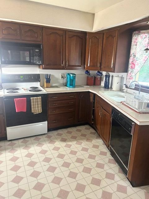 5 Estelle Rd, Poughkeepsie, NY 12601 - kitchen featuring black appliances, light countertops, light flooring, a sink, and dark brown cabinets