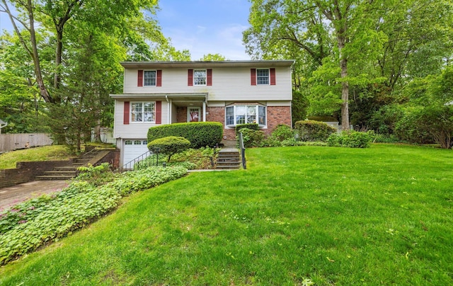 9 Gull Dr, Hauppauge, NY 11788 - view of front facade with a garage, a front lawn, brick siding, and stairway