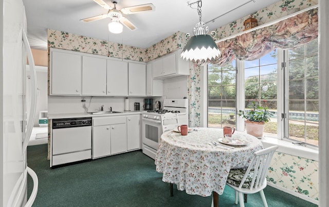 9 Gull Dr, Hauppauge, NY 11788 - kitchen featuring white appliances, healthy amount of natural light, light countertops, white cabinets, and wallpapered walls