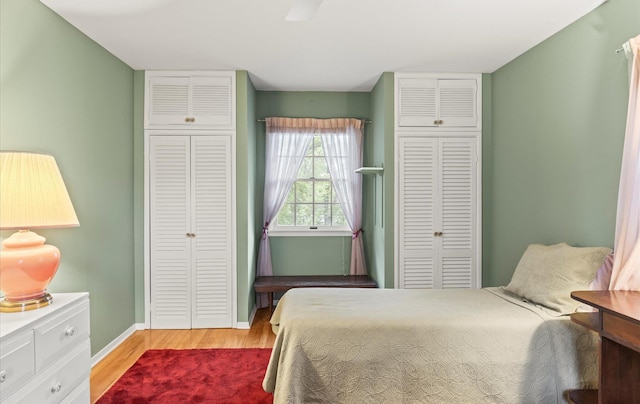 9 Gull Dr, Hauppauge, NY 11788 - bedroom featuring light wood-style floors, baseboards, and two closets