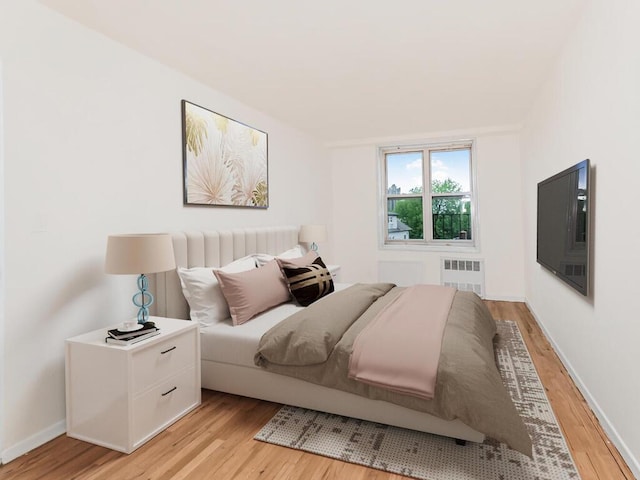 3311 Giles Pl Unit 5H, Bronx, NY 10463 - bedroom featuring radiator, light wood finished floors, and baseboards
