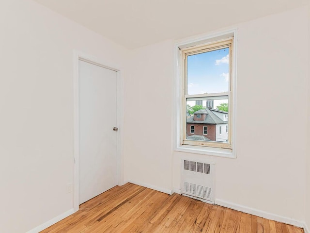 3311 Giles Pl Unit 5H, Bronx, NY 10463 - empty room featuring radiator heating unit, light wood-style floors, and baseboards
