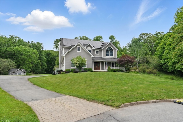 7 Gabriels Dr, Chester, NY 10918 - view of front facade featuring covered porch, solar panels, and a front lawn