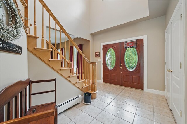 7 Gabriels Dr, Chester, NY 10918 - foyer with baseboard heating, tile patterned flooring, stairs, and baseboards