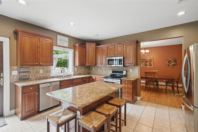 7 Gabriels Dr, Chester, NY 10918 - kitchen with appliances with stainless steel finishes, a sink, light tile patterned floors, a kitchen breakfast bar, and recessed lighting