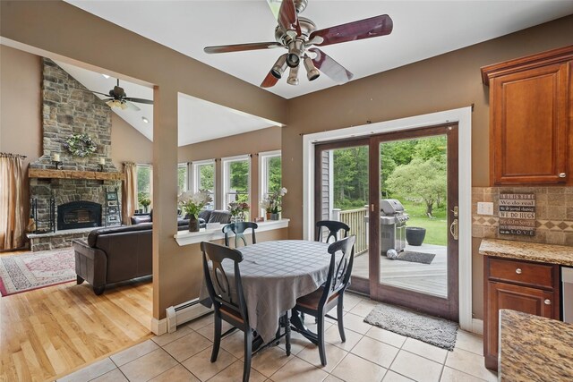 7 Gabriels Dr, Chester, NY 10918 - dining space with a ceiling fan, lofted ceiling, healthy amount of natural light, a fireplace, and light tile patterned floors