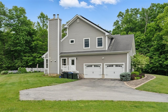 7 Gabriels Dr, Chester, NY 10918 - view of home's exterior with asphalt driveway, a yard, a chimney, and an attached garage