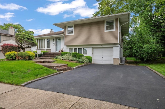 58 Briar Ln, Jericho, NY 11753 - tri-level home featuring asphalt driveway, brick siding, a front yard, and an attached garage