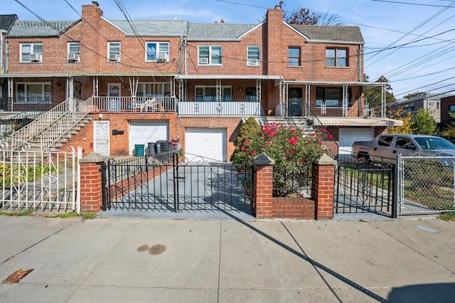 1149 E 219th St, Bronx, NY 10469 - view of property with an attached garage, brick siding, driveway, and a fenced front yard