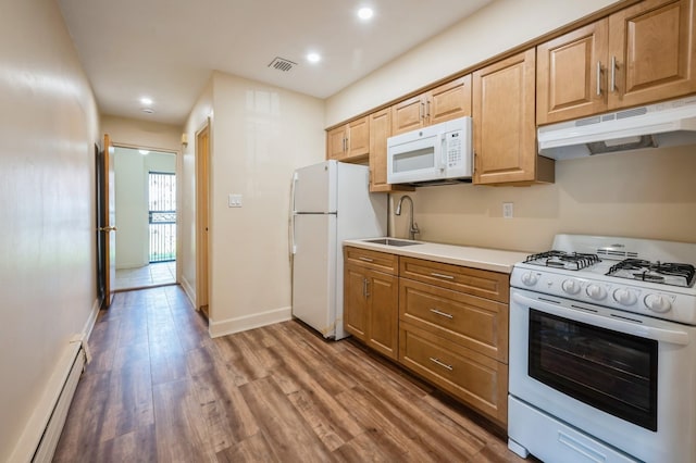 1149 E 219th St, Bronx, NY 10469 - kitchen featuring white appliances, baseboard heating, under cabinet range hood, wood finished floors, and recessed lighting