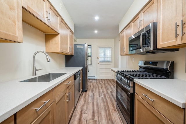 1149 E 219th St, Bronx, NY 10469 - kitchen with appliances with stainless steel finishes, light wood-type flooring, light countertops, recessed lighting, and a baseboard radiator