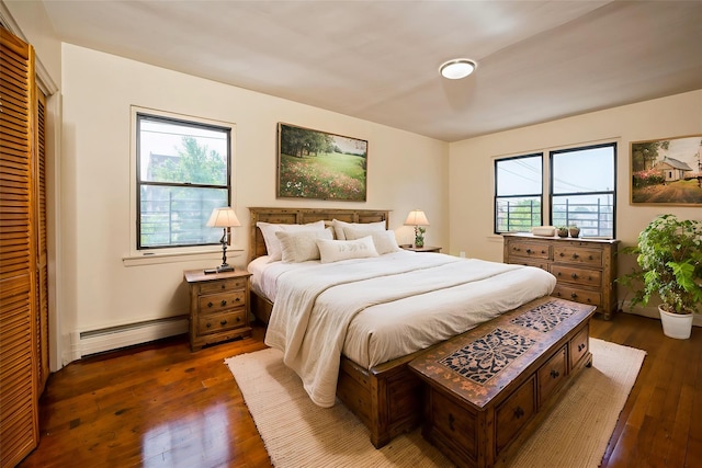 1149 E 219th St, Bronx, NY 10469 - bedroom with a baseboard radiator and dark wood-style flooring