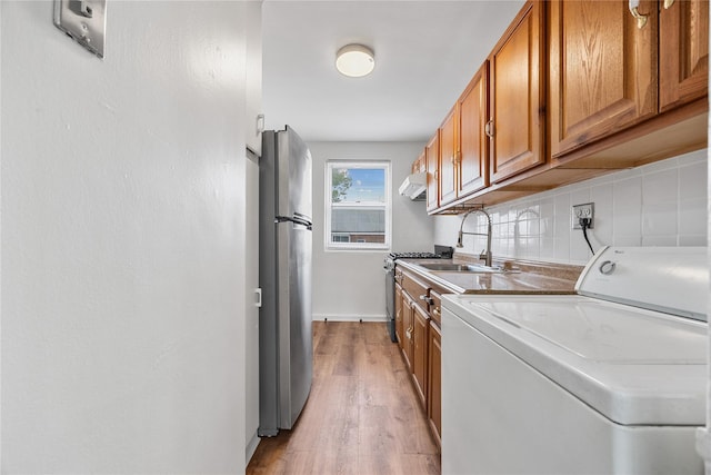 247-78 77th Cres Unit B, Bellerose, NY 11426 - washroom featuring washer / dryer, light wood-style floors, and baseboards