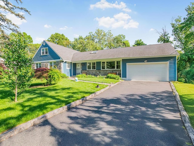 81 Winding Brook Rd, New Rochelle, NY 10804 - view of front of home with driveway, an attached garage, stone siding, and a front lawn