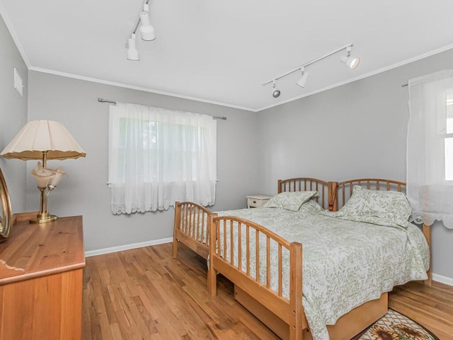 81 Winding Brook Rd, New Rochelle, NY 10804 - bedroom featuring track lighting, wood finished floors, crown molding, and baseboards