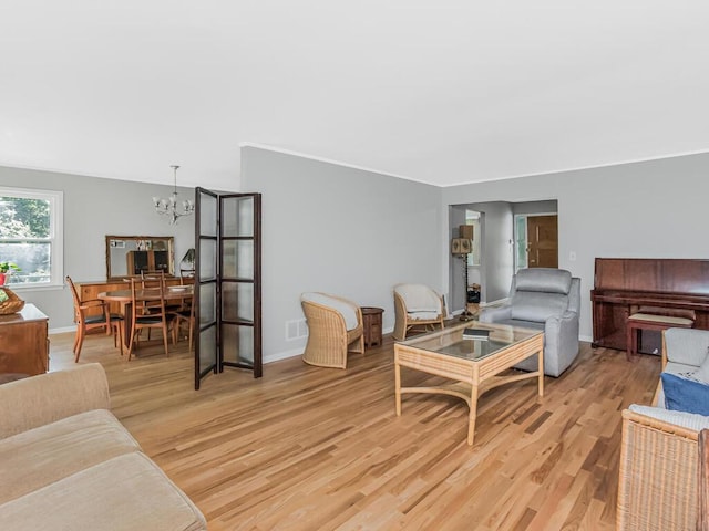 81 Winding Brook Rd, New Rochelle, NY 10804 - living area featuring a chandelier, light wood finished floors, and baseboards