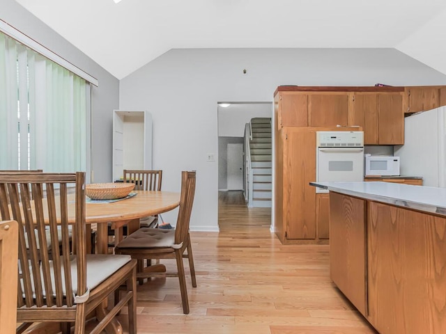 81 Winding Brook Rd, New Rochelle, NY 10804 - kitchen with white appliances, lofted ceiling, light wood finished floors, light countertops, and brown cabinets