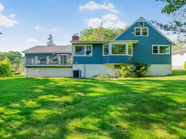 81 Winding Brook Rd, New Rochelle, NY 10804 - back of property with a chimney, a lawn, a wooden deck, and central AC unit