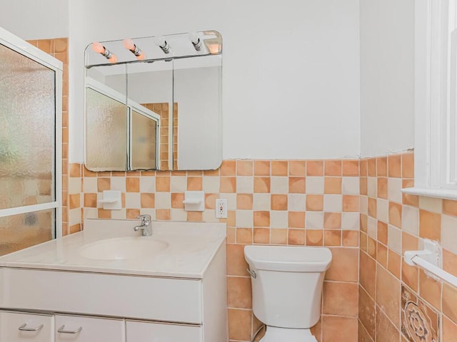 81 Winding Brook Rd, New Rochelle, NY 10804 - bathroom with vanity, toilet, an enclosed shower, and tile walls