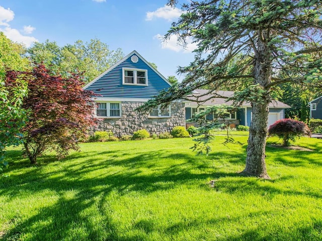 81 Winding Brook Rd, New Rochelle, NY 10804 - rear view of property featuring stone siding, a lawn, and a garage