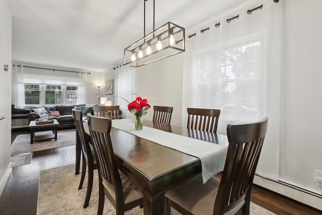 32 Meadow Rd, Montrose, NY 10567 - dining area with wood finished floors, a baseboard radiator, and a chandelier