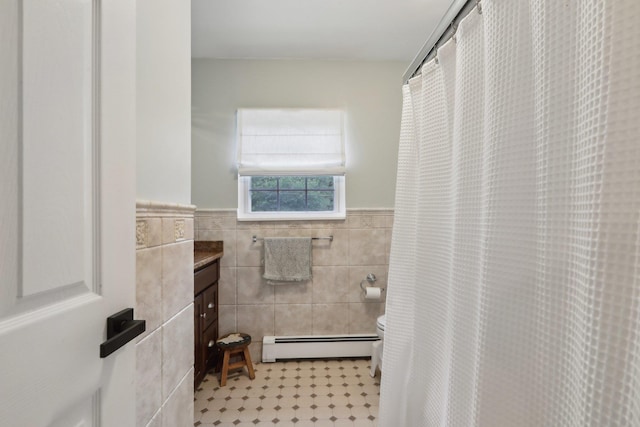 32 Meadow Rd, Montrose, NY 10567 - bathroom featuring a baseboard heating unit, vanity, toilet, tile walls, and wainscoting