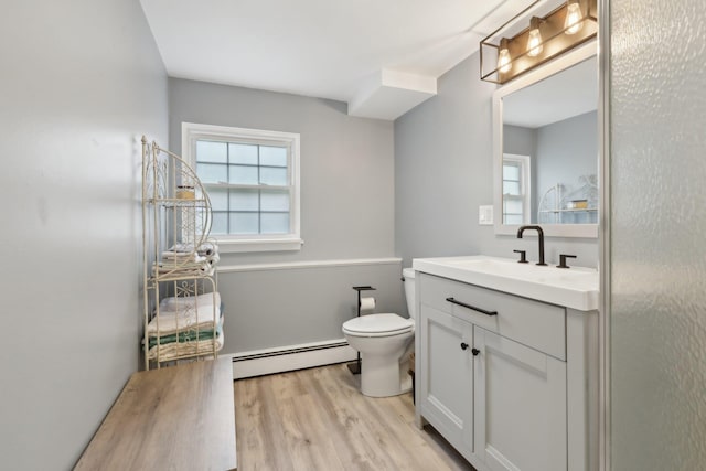 32 Meadow Rd, Montrose, NY 10567 - bathroom featuring a baseboard heating unit, vanity, wood finished floors, and toilet