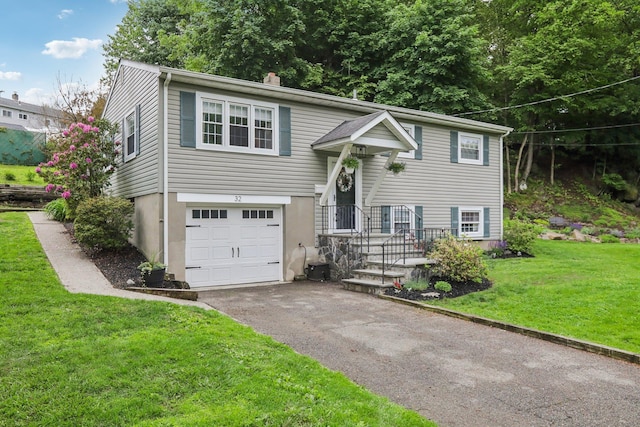 32 Meadow Rd, Montrose, NY 10567 - raised ranch with asphalt driveway, a front yard, and a garage