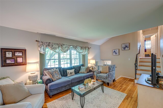 8 Baylor Dr, Smithtown, NY 11787 - living area with lofted ceiling, light wood-style floors, and stairway