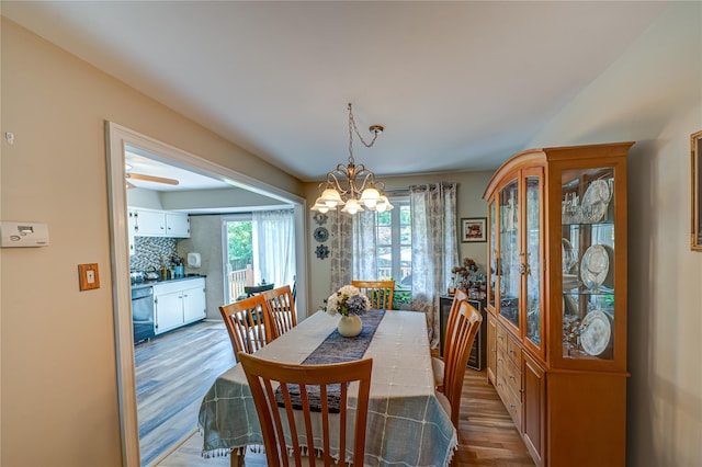 8 Baylor Dr, Smithtown, NY 11787 - dining space with a chandelier and wood finished floors
