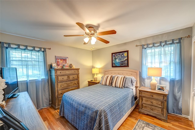 8 Baylor Dr, Smithtown, NY 11787 - bedroom with multiple windows, light wood-type flooring, and a ceiling fan
