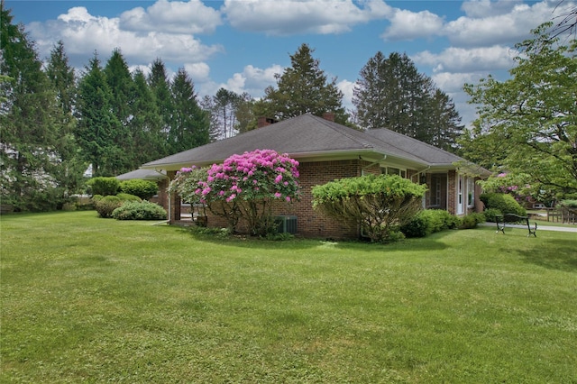 29 Maiden Ln, Port Jervis, NY 12771 - view of home's exterior with a lawn, a chimney, brick siding, and central air condition unit