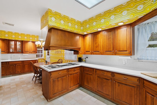 29 Maiden Ln, Port Jervis, NY 12771 - kitchen featuring cooktop, brown cabinetry, a sink, and light countertops