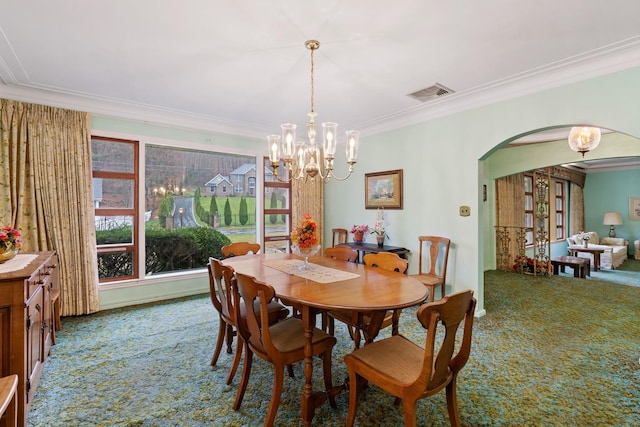 29 Maiden Ln, Port Jervis, NY 12771 - carpeted dining room featuring arched walkways, ornamental molding, and a chandelier