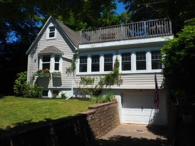 20 Locust Rd, Wading River, NY 11792 - view of front facade featuring a balcony, an attached garage, a front yard, and driveway