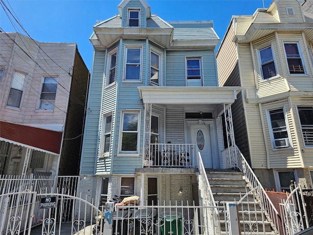 2675 Marion Ave, Bronx, NY 10458 - townhome / multi-family property featuring a gate and covered porch