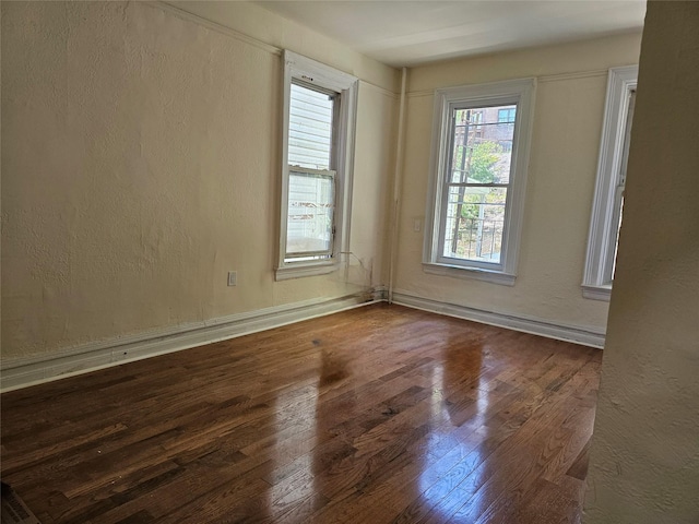 2675 Marion Ave, Bronx, NY 10458 - empty room featuring wood finished floors, a textured wall, and baseboards