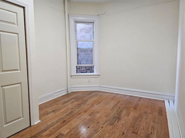 2675 Marion Ave, Bronx, NY 10458 - unfurnished room featuring wood finished floors, a baseboard radiator, and baseboards