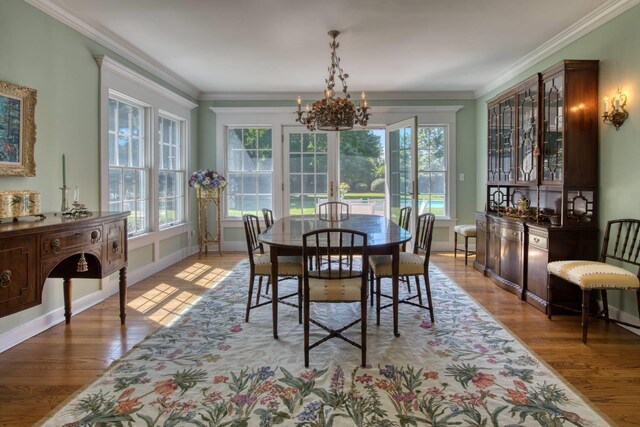 73 S Rd, Westhampton Beach, NY 11978 - dining area with a chandelier, healthy amount of natural light, wood finished floors, baseboards, and crown molding