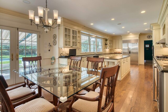 73 S Rd, Westhampton Beach, NY 11978 - dining area featuring crown molding, light wood-type flooring, a chandelier, and recessed lighting