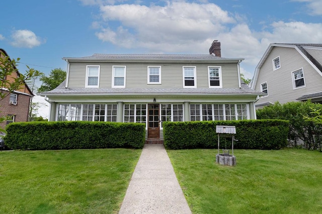 31 Heminway Ave, New Rochelle, NY 10801 - view of front of home with a chimney and a front yard