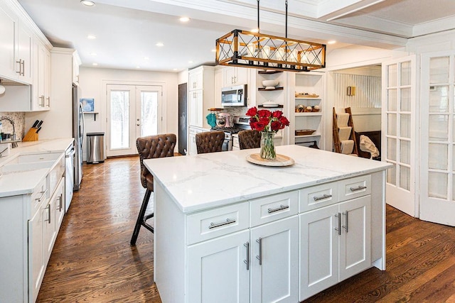31 Heminway Ave, New Rochelle, NY 10801 - kitchen with stainless steel appliances, french doors, a center island, dark wood-type flooring, and backsplash