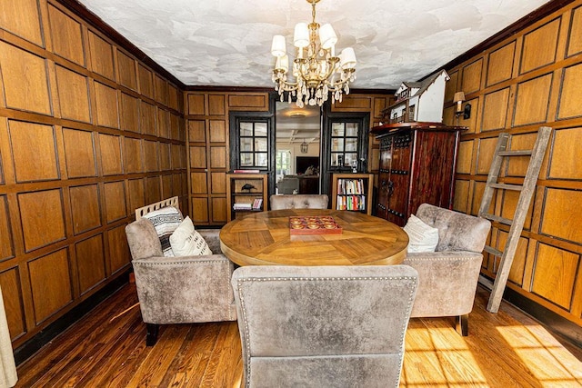 31 Heminway Ave, New Rochelle, NY 10801 - sitting room with a chandelier, dark wood-style flooring, wood walls, and crown molding