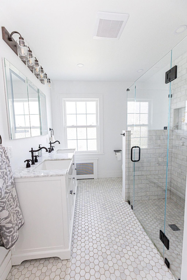 31 Heminway Ave, New Rochelle, NY 10801 - bathroom with double vanity, a stall shower, tile patterned floors, recessed lighting, and baseboards