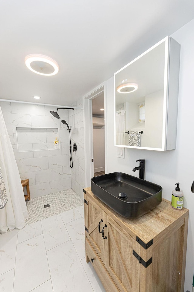 31 Heminway Ave, New Rochelle, NY 10801 - bathroom featuring marble look tiles, tiled shower, and vanity