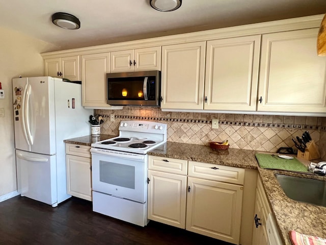 75A Enfield Ct Unit 75A, Ridge, NY 11961 - kitchen with white appliances, decorative backsplash, a sink, dark wood finished floors, and white cabinetry
