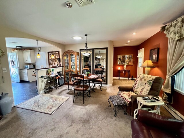 75A Enfield Ct Unit 75A, Ridge, NY 11961 - dining area with arched walkways, carpet, and a baseboard heating unit