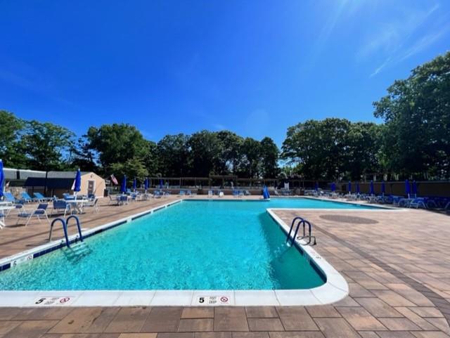 75A Enfield Ct Unit 75A, Ridge, NY 11961 - community pool featuring a patio