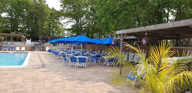 75A Enfield Ct Unit 75A, Ridge, NY 11961 - community pool featuring a patio area and view of wooded area
