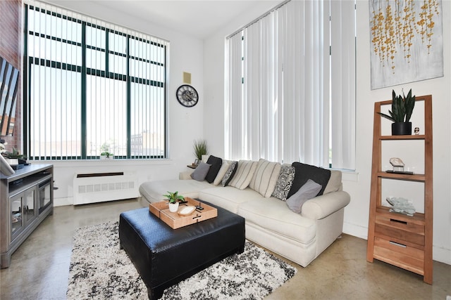 70 S Main St Unit 307-Ph, Freeport, NY 11520 - living room featuring concrete flooring and radiator heating unit